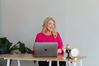 Paula Marie at her desk getting ready for a speaking event.